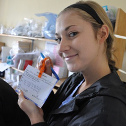 student pharmacist shows vaccine card